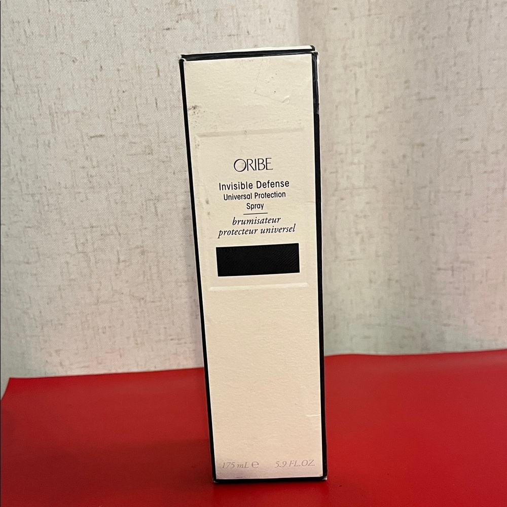 Oribe Invisible Defense Spray in Black and White Packaging